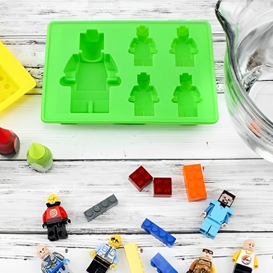Moule à gateau verte présentée avec différentes figurines , de robots
